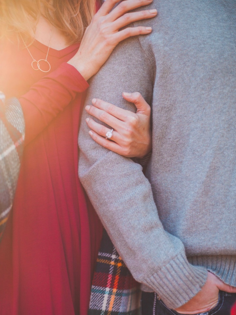 Couple holding arms